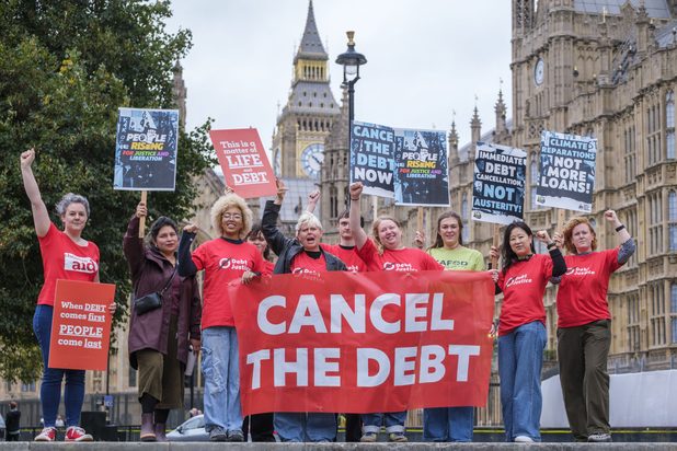 Campaigners from Debt Justice, Christian Aid and CAFOD, stand outside Parliament in London on the Global Day of Action.