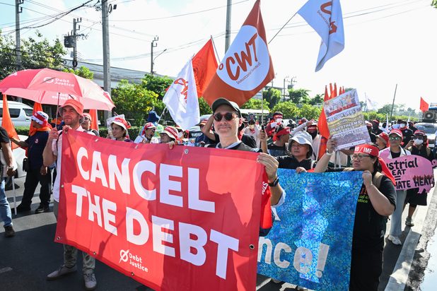 Debt Justice joins the march in Bangkok, carrying our "Cancel the Debt" banner alongside campaigners from around the world.
