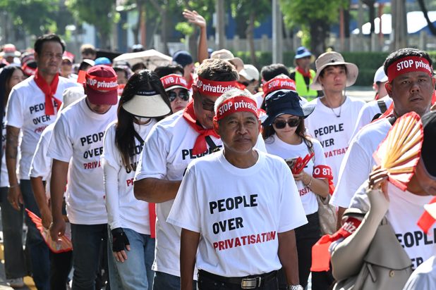 Campaigners wearing "People over privatisation" T-shirts and "Stop privatisation" headbands.